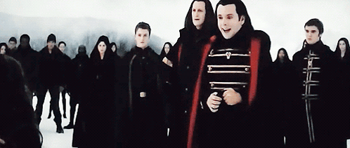 People Standing in Snow One Red Cape