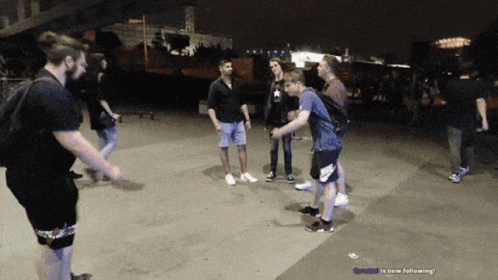 People Standing On Sidewalk Saying Is Now Following GIF