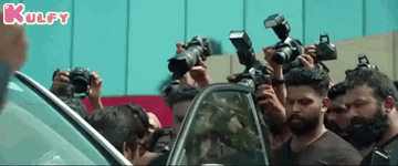 People Taking Photos of Man by Car