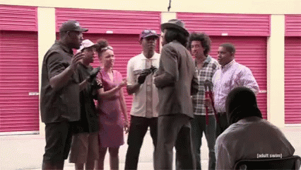 People Talking in Front of Pink Garage Door