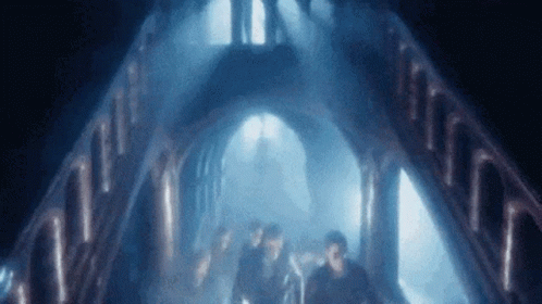 People Walking in Dark Tunnel with Blue Light