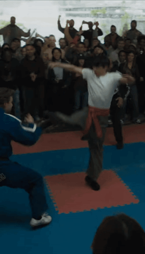 People Watching Man Kick Another In Air GIF
