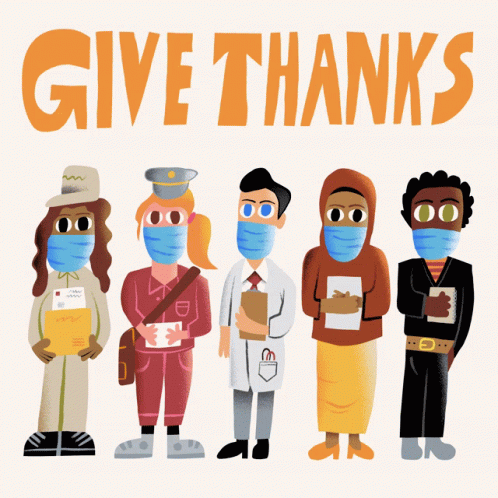 People Wearing Face Masks in Front of Give Thanks Sign