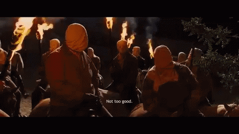 People Wearing Masks Holding Torches Saying Not Too Good