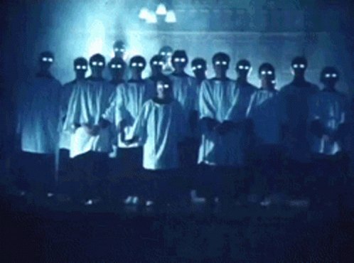 People With Glowing Eyes in Dark Room