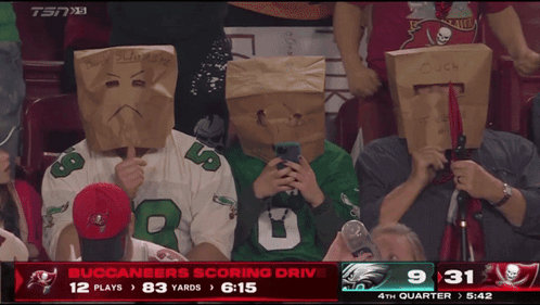People With Paper Bags Watching Buccaneers Game