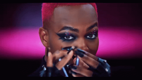 Person Applying Makeup On Pink Background GIF