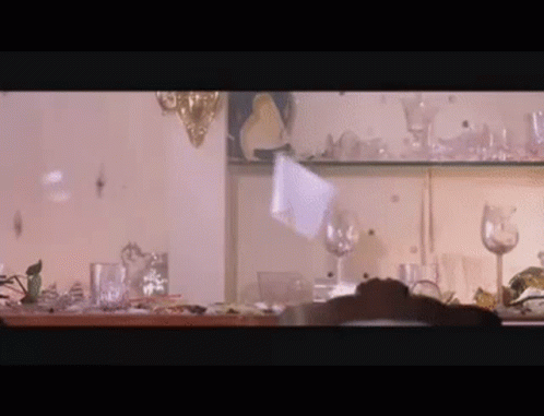 Person at Shelf Full of Glasses and Plates