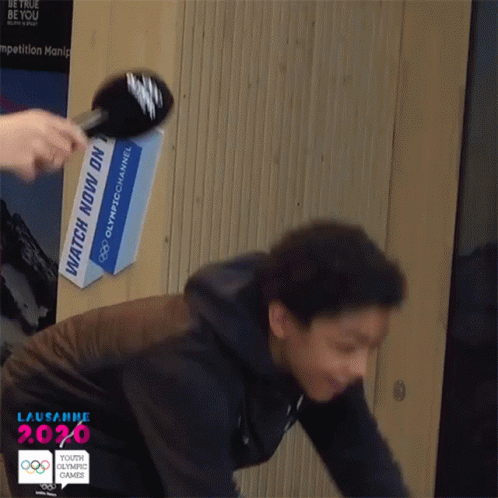 Person Being Interviewed in Front of Watch Now Sign