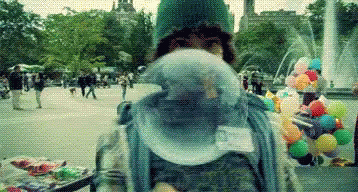 Person Blowing Bubble Gum by Fountain