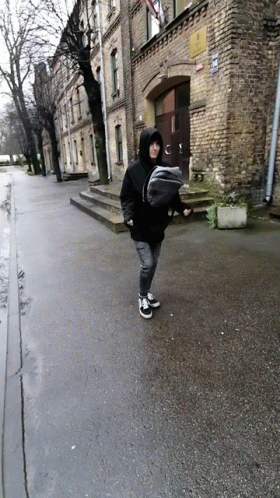 Person Carrying Baby In Sling On Street