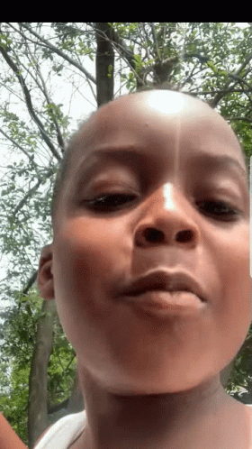 Person Close Up With Tree In Background GIF