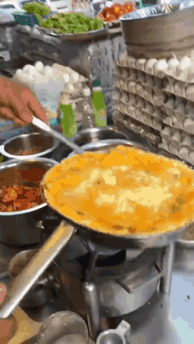 Person Cooking Omelet on Stove in Kitchen