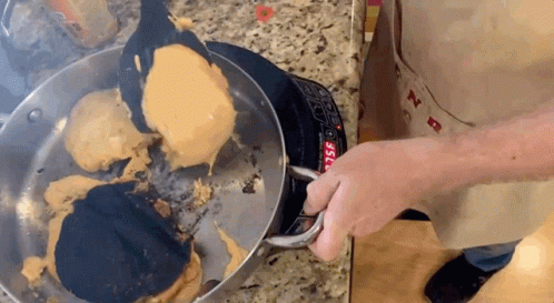 Person Cooking Pancakes on Stove Top
