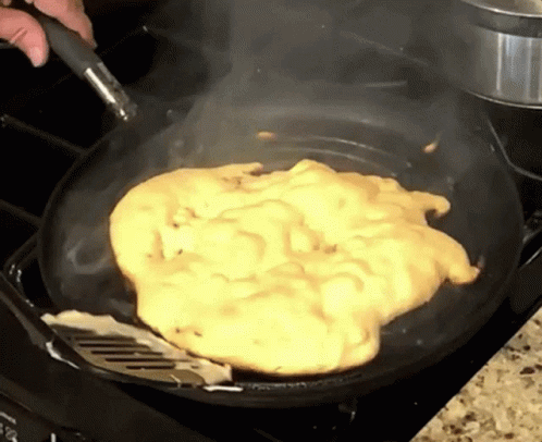 Person Cooking Scrambled Eggs