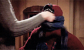 Person Covering Another's Mouth With Scarf