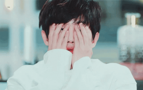 Person Covering Face With Hands Bottle Of Perfume GIF