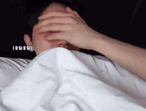 Person Covering Face with White Blanket with Asian Writing