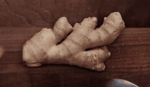 Person Cutting Ginger with Knife