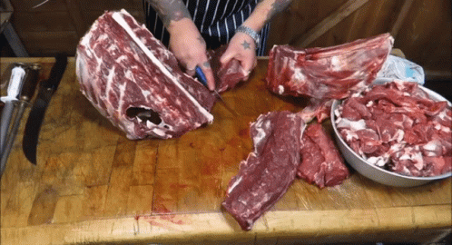 Person Cutting Large Meat Piece