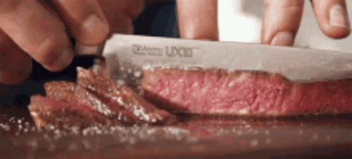 Person Cutting Meat With U-Cut Knife