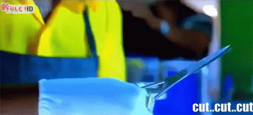 Person Cutting Paper With Scissors and Cut Cut Cut Visible