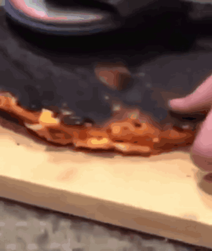 Person Cutting Pizza with Knife
