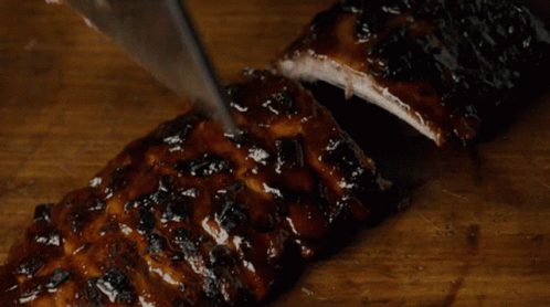 Person Cutting Ribs With Knife