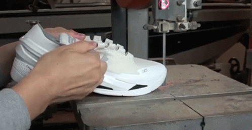 Person Cutting Shoe With Band Saw GIF