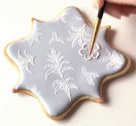 Person Decorating Cookie With Brush