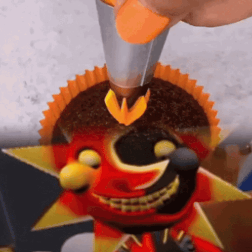 Person Decorating Cupcake With Smiley Face