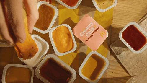 Person Dipping Chicken Nugget In Creamy Chili Sauce GIF