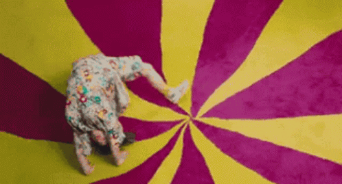 Person Doing Handstand on Colorful Swirl Carpet