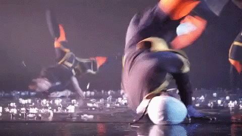 Person Doing Handstand on Stage with Crowd