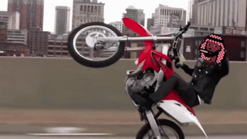 Person Doing Motorcycle Trick With Smiley Helmet