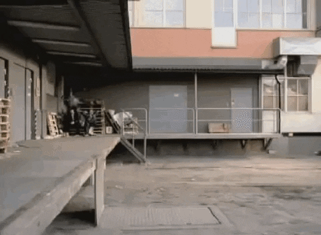 Person Doing Trick On Ramp In Warehouse GIF