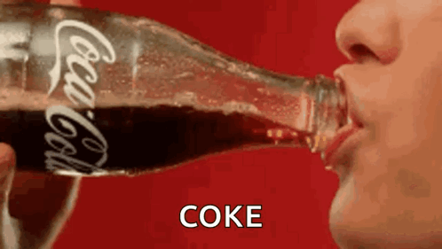 Person Drinking Bottle of Coca Cola