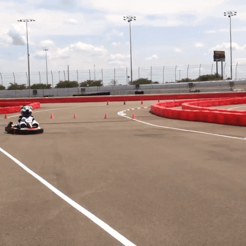 Person Driving Go Kart Down Track