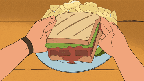 Person Eating Sandwich With Chips