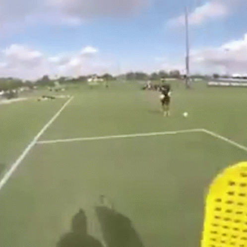 Person Flying Frisbee on Soccer Field
