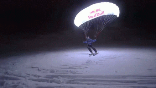 Person Flying Parachute That Says Red Bull