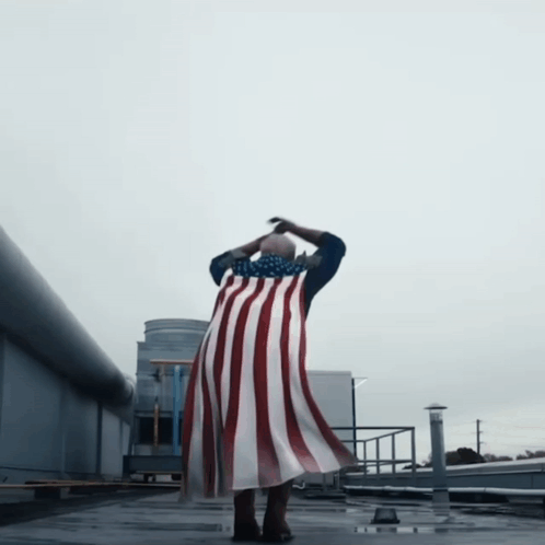 Person Flying with American Flag Cape