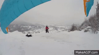 Person Flying With Parachute in Snow