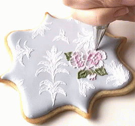 Person Frosting Cookie with White Frosting Bag
