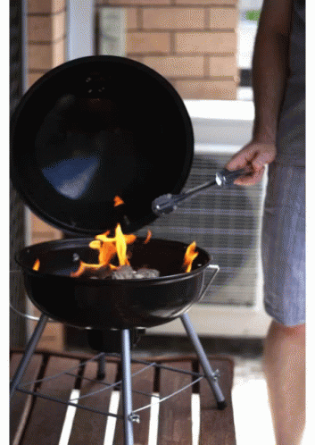 Person Grilling Meat on Small Grill