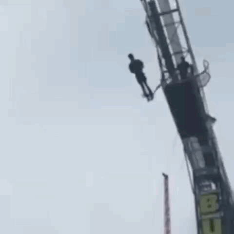 Person Hanging From Bungee Jumping Tower