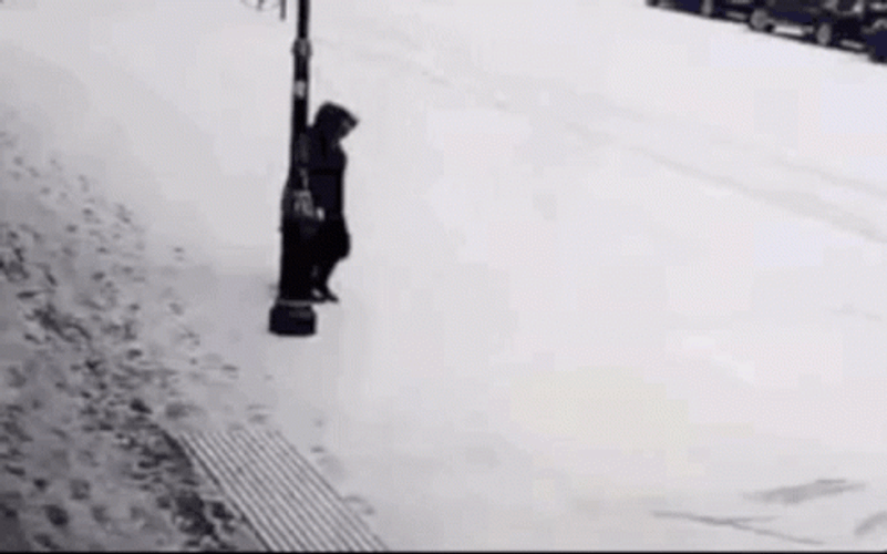 Person Hilariously Slipping On Ice While Walking GIF