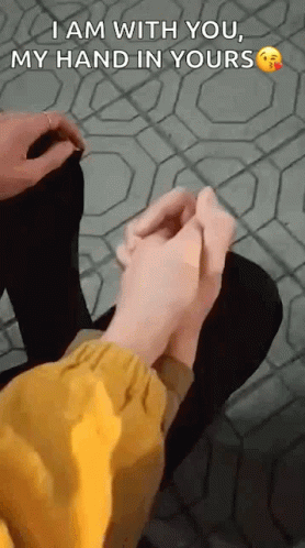 Person Holding Another's Hand Sitting on Tiled Floor