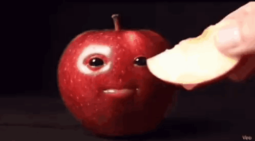 Person Holding Apple Slice Near Apple Face GIF