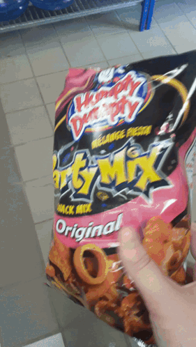 Person Holding Bag of Chunky Monkey Snack Mix Original